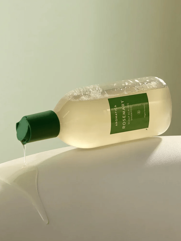 AROMATICA Rosemary Scalp Scaling Shampoo bottle with green cap, showcasing its refreshing formula for scalp health.