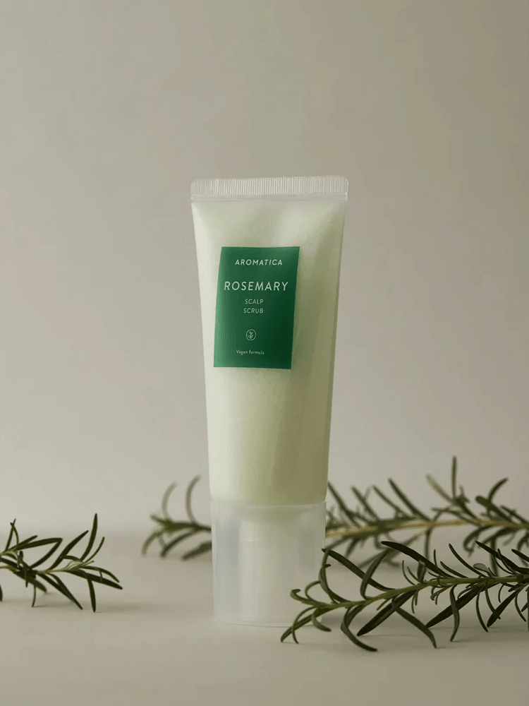 AROMATICA Rosemary Scalp Scrub in a tube with rosemary leaves, designed for scalp cleansing and exfoliation.