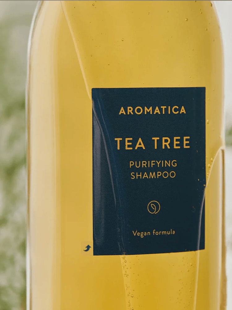 AROMATICA Tea Tree Purifying Shampoo bottle with vegan formula, designed for oily scalps and fresh cleansing.