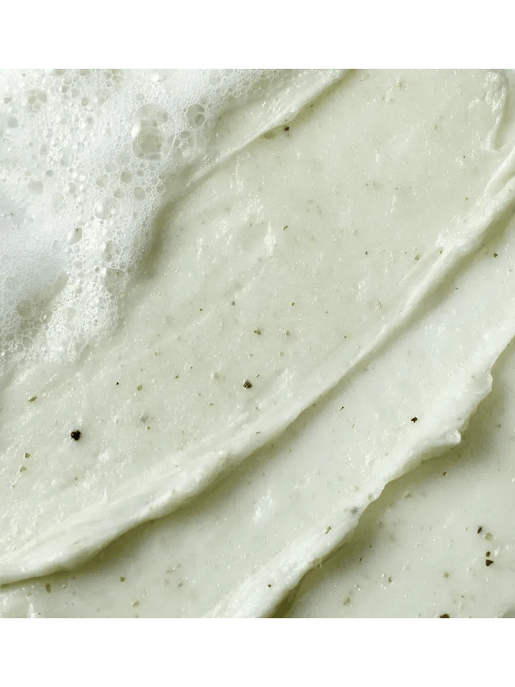 BEPLAIN Mung Bean Ph-Balanced Cleansing Foam texture with bubbles and exfoliating particles on a light background.
