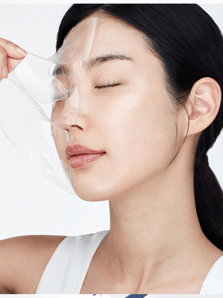 A woman applying the BIODANCE Hydro Cera-nol Real Deep Mask to her face, showcasing its skincare benefits.