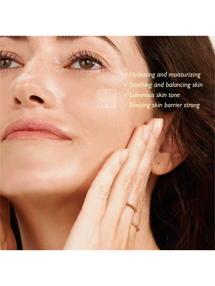 Close-up of a woman applying HARUHARU WONDER Black Rice Hyaluronic Toner, showcasing hydrating and soothing benefits.
