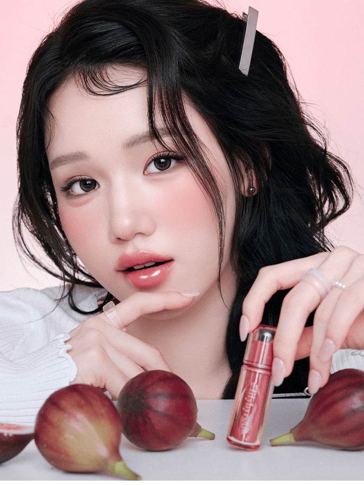 LILYBYRED Bloody Liar Coating Tint 26D displayed with a model, showcasing glossy lips and natural makeup.