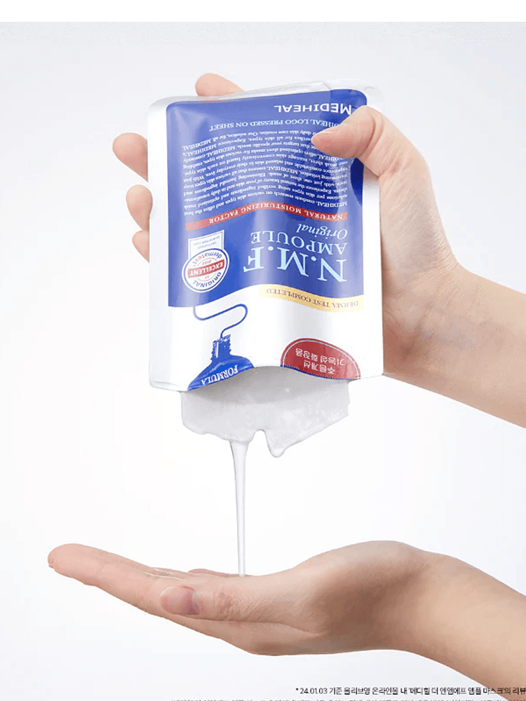 MEDIHEAL THE N.M.F Ampoule Mask being poured into a hand, showcasing its hydrating formula.