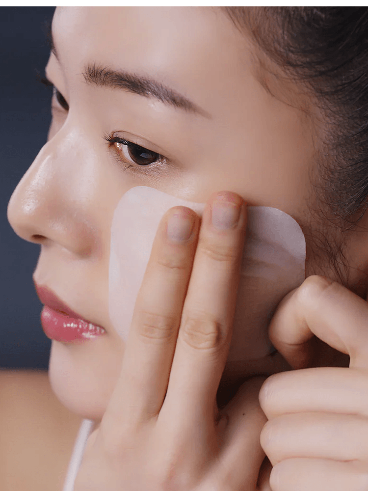 Person applying MEDIHEAL Teatree Trouble Pad to the face for soothing skin care.