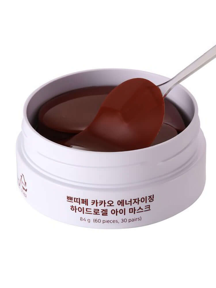 PETITFEE Cacao Energizing Hydrogel Eye patch 84g with spoon showing the brown eye patches inside the jar.