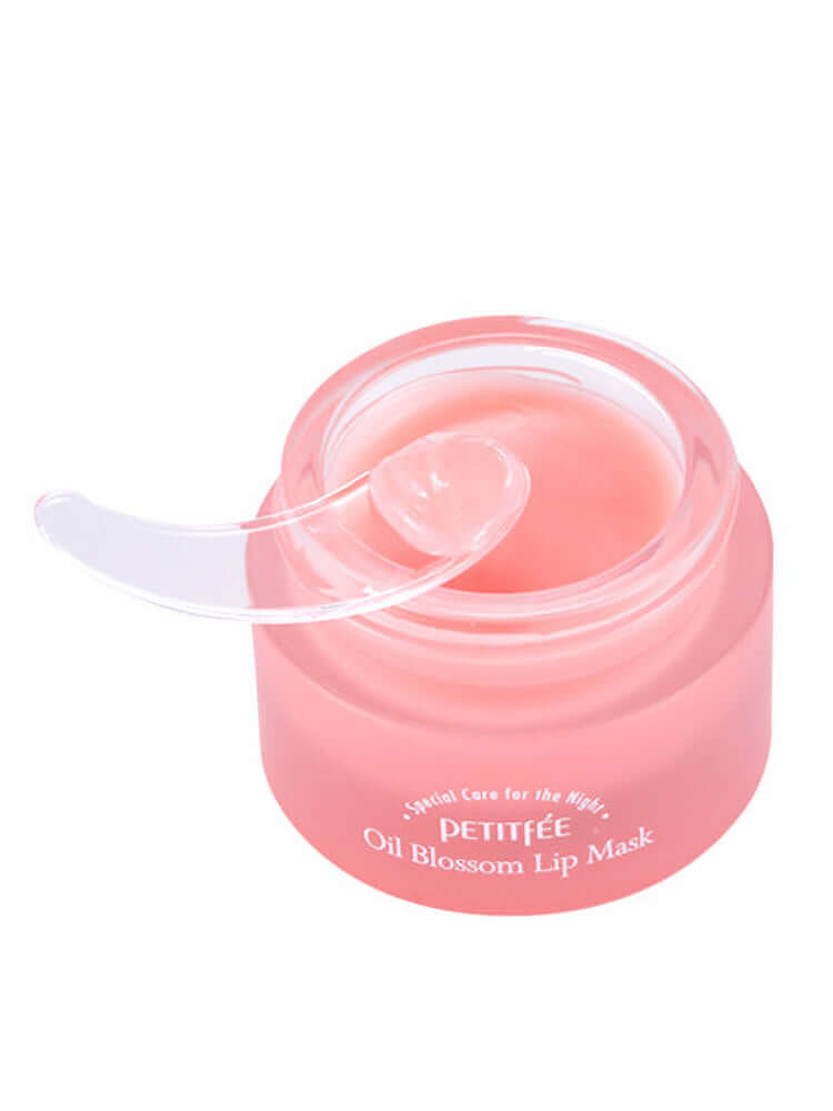 PETITFEE Oil Blossom Lip Mask 15g Camelia Seed Oil in a pink jar with a clear spatula for easy application.
