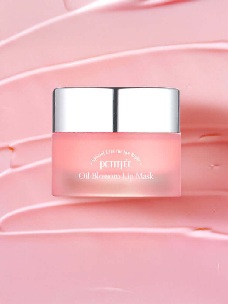 PETITFEE Oil Blossom Lip Mask 15g Camelia Seed Oil in a jar on a pink background with glossy lip mask texture.