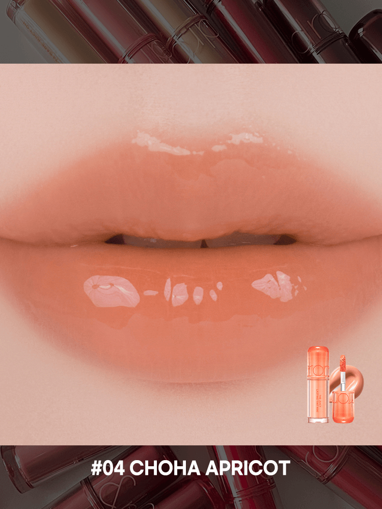 Close-up of lips tinted with rom&nd The juicy lasting tint in #04 Choha Apricot, showcasing glossy finish and color.
