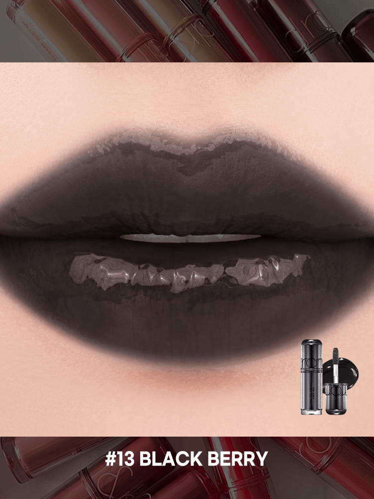 romand juicy lasting tint in #13 Black Berry, showcasing a glossy, dark lip color against a colorful background.