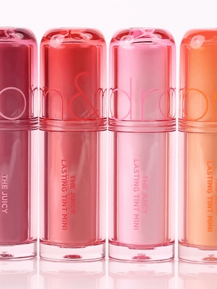 rom&nd The juicy lasting tint Mini 1g lip tint collection in various shades on a white background.