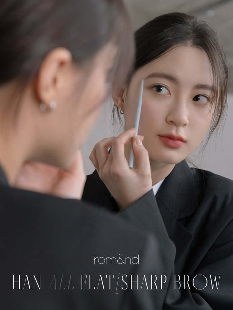 rom&nd Han All Flat / Sharp Brow being applied for naturally defined brows in a stylish setting.