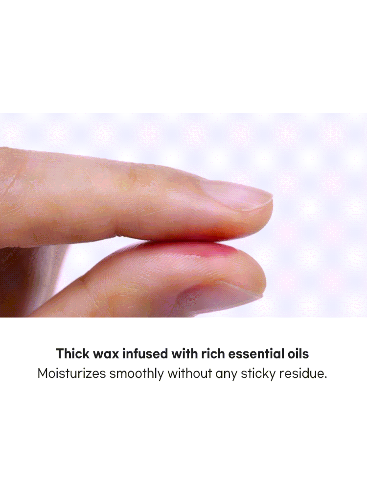 Hand holding thick wax infused with essential oils, demonstrating smooth moisturizing without sticky residue.