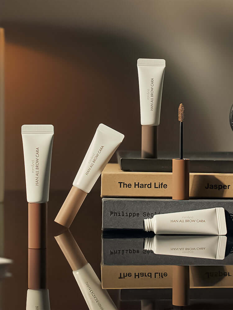 rom&nd Han All Brow Cara products displayed on a reflective surface, showcasing Korean Cosmetics New Zealand.