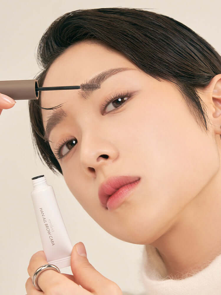 Close-up of a model applying rom&nd Han All Brow Cara, showcasing Korean Cosmetics New Zealand for perfect brows.