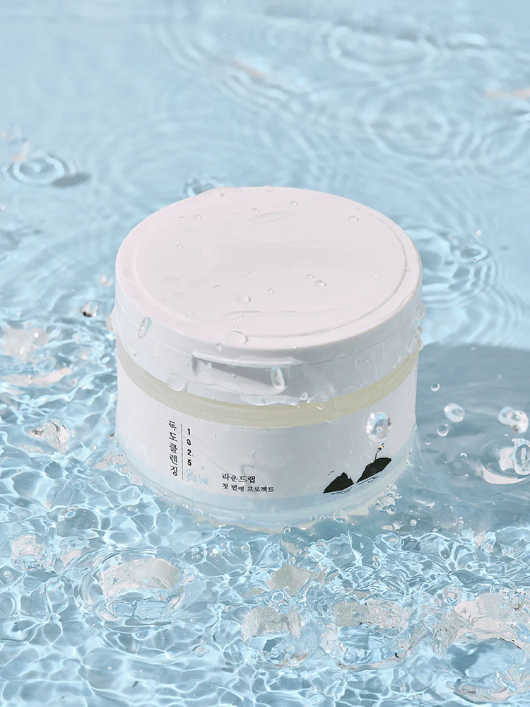 ROUND LAB 1025 Dokdo Cleansing Balm 100ml in water, showcasing its refreshing cleanse and moisturizing properties.