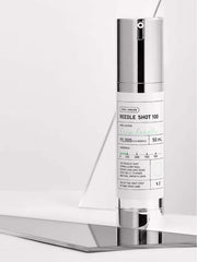 VT Reedle Shot 100 50ml on a reflective surface, showcasing its CICA pre-care skin treatment.
