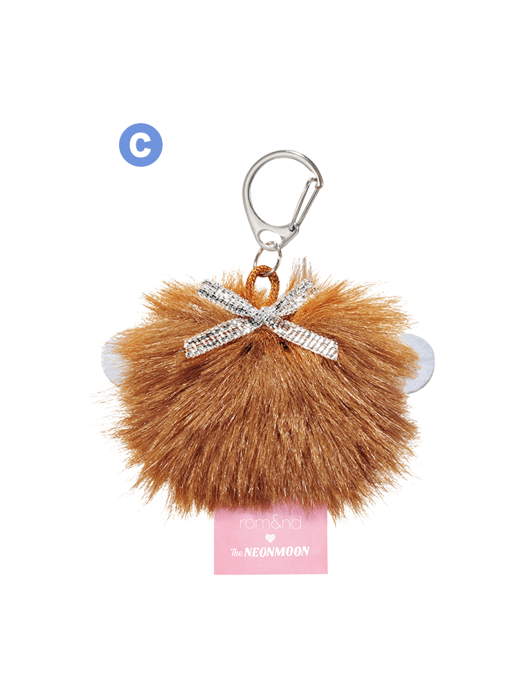 rom&nd Neonmoon doll keychain with fluffy brown pom-pom and silver bow, perfect for adding charm and style.
