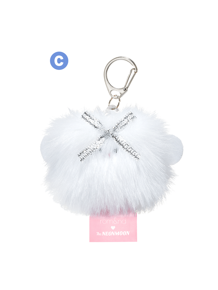 rom&nd Neonmoon doll fluffy keychain accessory with silver accents and a pink tag