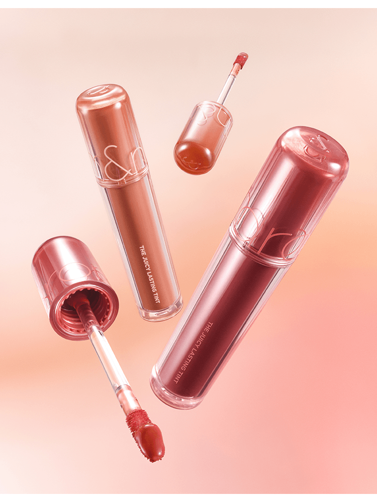 romnd The Juicy Lasting Tint NEW WARM lip tints in shades with applicators on a soft gradient background.